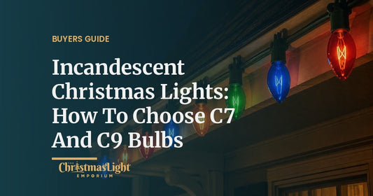 Large C9 incandescent Christmas bulbs in transparent red, blue, green and orange glass glowing along a roofline at night
