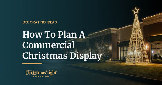 Commercial storefront outlined with warm white C9 lights beside a large lighted steel display tree at night