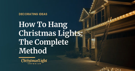 Two-story home outlined with warm white C9 Christmas lights at dusk, ladder against the fascia