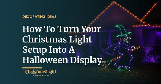 Suburban house outlined in orange lights at night with a lighted steel witch-on-a-broom display glowing in the front yard