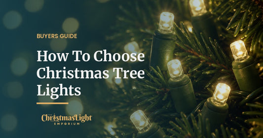 Close-up of warm white 5mm LED Christmas lights on green wire glowing among the branches of a fir Christmas tree at night