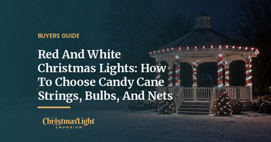 A white park gazebo at night with columns spiral-wrapped in red and cool white mini lights like candy canes, its roof edge outlined in alternating red and white C9 bulbs, and small evergreens in red and white lights by the steps, on a snowy evening