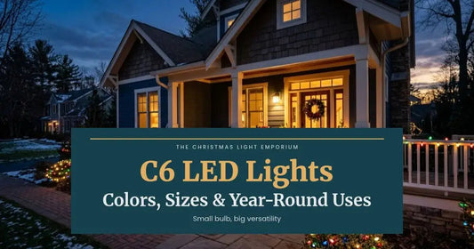 Blue-gray home with warm white roofline lights and a multicolor-lit porch railing at dusk. Branded title card from The Christmas Light Emporium reads: C6 LED Lights — Colors, Sizes & Year-Round Uses.