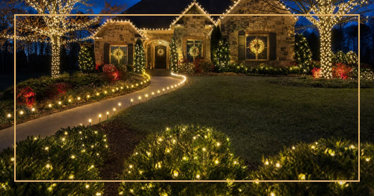 Stunning front yard Christmas display with LED lights on trees, wreaths, and roofline