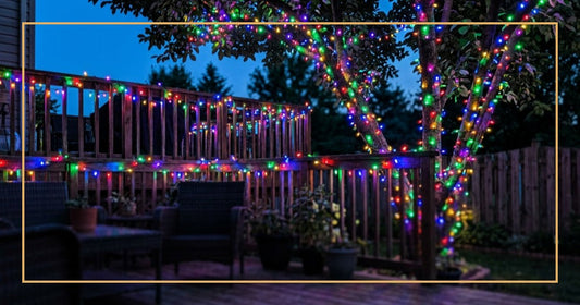 Colorful LED light strings illuminating a backyard patio and trees at twilight