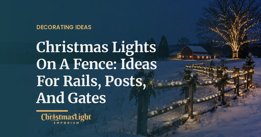 A rustic split-rail fence crossing a snowy field at night, its rails wrapped in warm white LED Christmas lights and its posts topped with evergreen swags, with a lit oak tree and a red barn in the distance