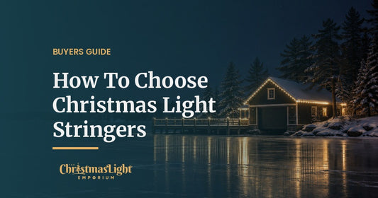A wooden boathouse and dock on a frozen lake at night, the roofline and dock railing outlined in evenly spaced warm white C9 Christmas bulbs reflected on the ice