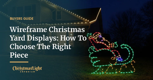 A lighted wireframe Santa in sleigh Christmas yard display glowing in green, red, and gold on a suburban front lawn at night, with warm white C9 Christmas lights on the roofline behind it