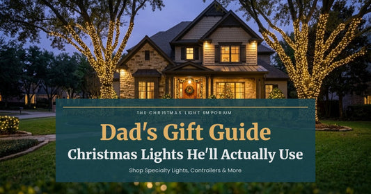 Title image of a beautiful home exterior with warm white Christmas lights wrapped around oak trees at twilight. Image text reads: Dad's Gift Guide / Christmas Lights He'll Actually Use / Shop Specialty Lights, Controllers & More