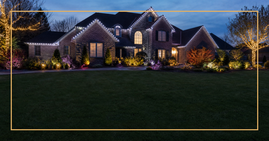 Suburban home at dusk showing warm white cool white and colored LED Christmas lights on trees roofline and garden