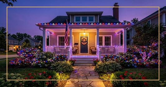 Suburban home at dusk with red, white, and blue LED string lights glowing on roofline, porch railings, and front bushes for 4th of July
