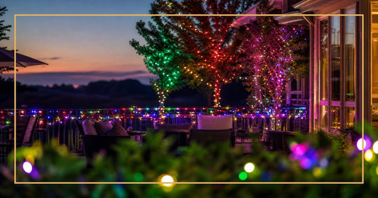 Patio at dusk with colorful LED light strings wrapped around railings and trees
