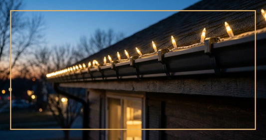Christmas light clips attached to house gutters with LED lights glowing at dusk