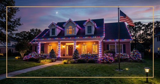 Suburban home at twilight with red, white, and blue LED Christmas lights glowing on roofline and porch columns, American flag in the yard