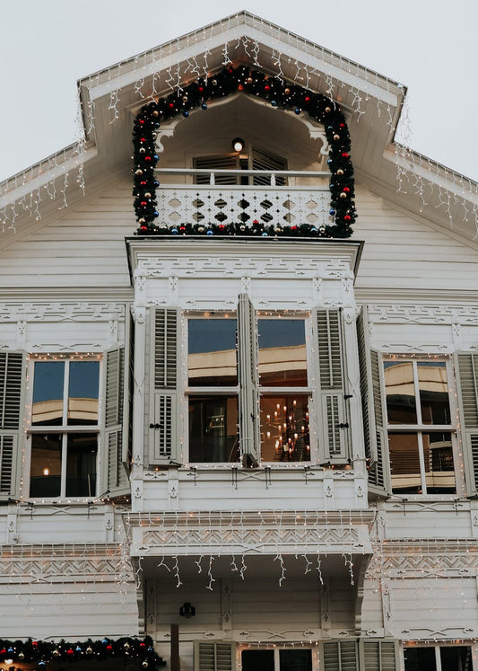 Cool white LED icicle lights outlining a house roofline in winter