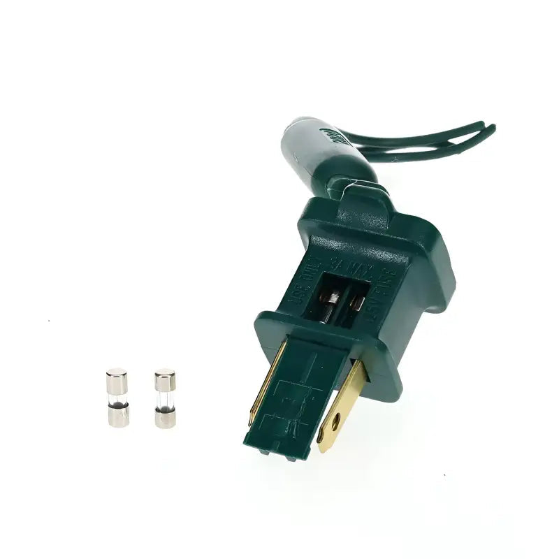 Green fused male plug with the fuse door open next to two spare 3-amp fuses