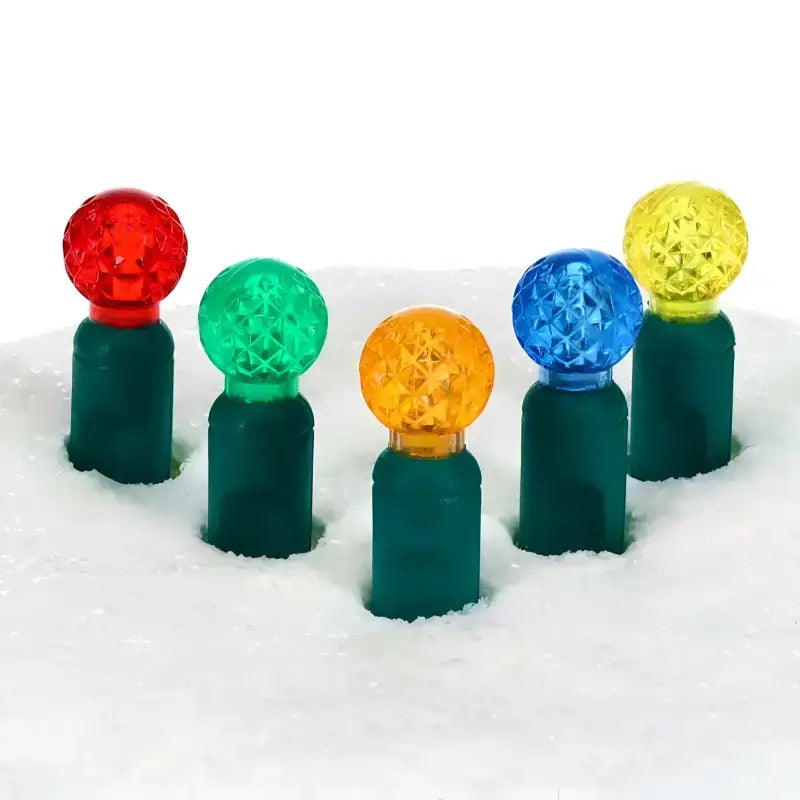 70 G12 Multicolor LED Christmas light string showing the round raspberry-shaped globe lens style in multiple vivid colors, 4-inch spacing on green wire
