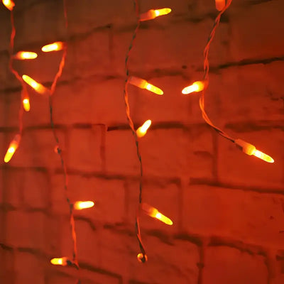 Orange 70-count M5 LED icicle Christmas lights on white wire