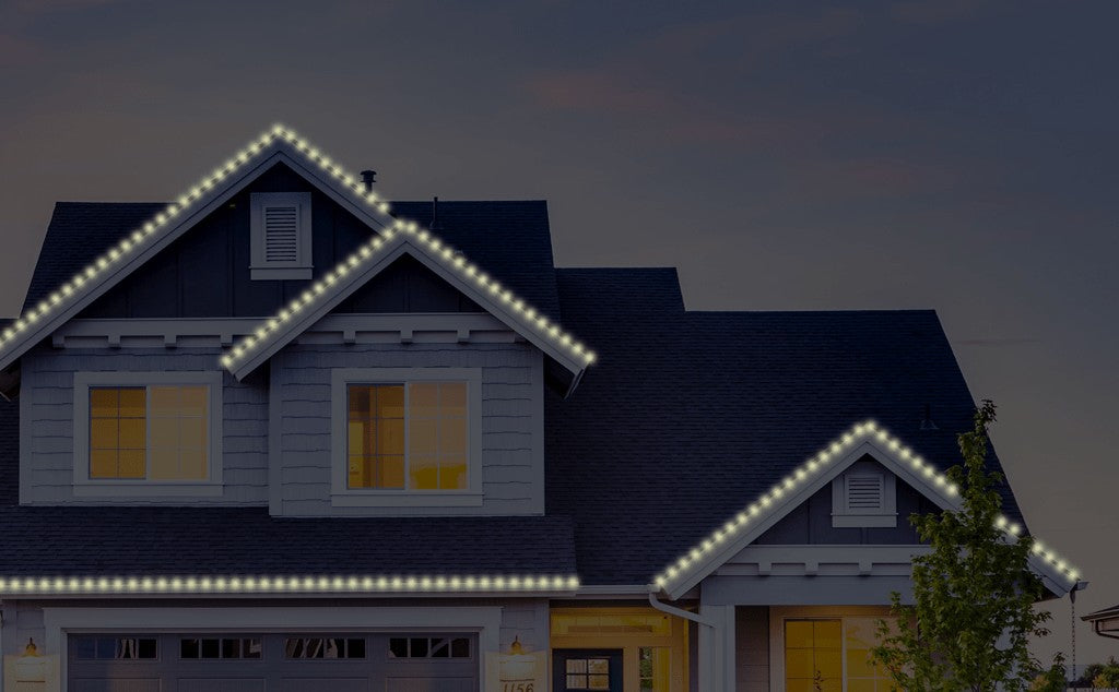 Two story house at dusk with warm white C9 LED Christmas lights outlining the roofline