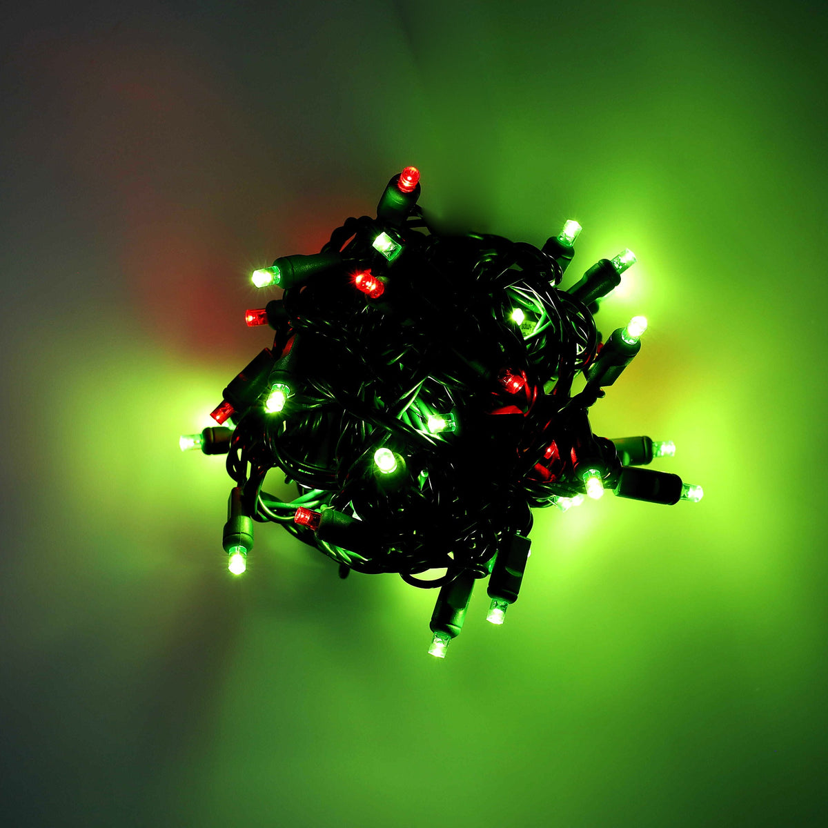 Bundled 50-light ColorCraft® Humbug 5mm LED string lit in lime green and red against a dark background