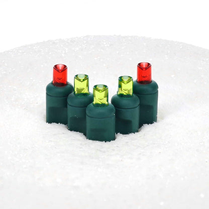 Unlit ColorCraft® Humbug 5mm LED lenses, two red and three lime green, on green sockets set in white snow