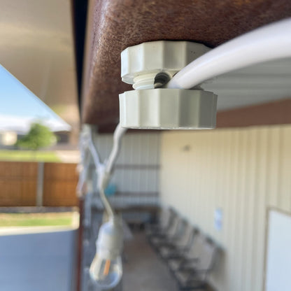 Lite-Netics jumbo magnetic wire clamp routing a light cord along a metal building fascia