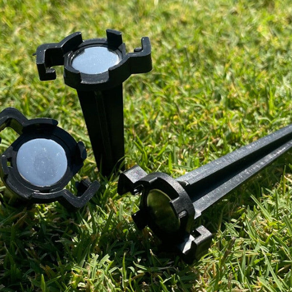 Group of black Lite-Netics metal base lawn stakes with magnetic C9 sockets attached