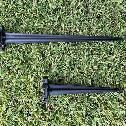 Two black Lite-Netics metal base lawn stakes on grass