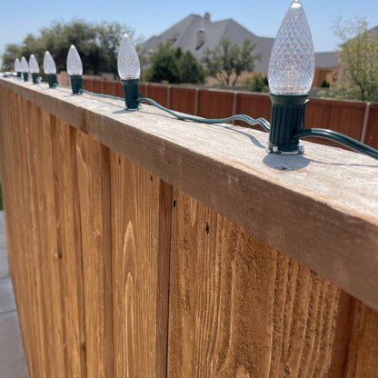 Lite-Netics magnetic C9 sockets mounted on nickel clips along a wood fence top